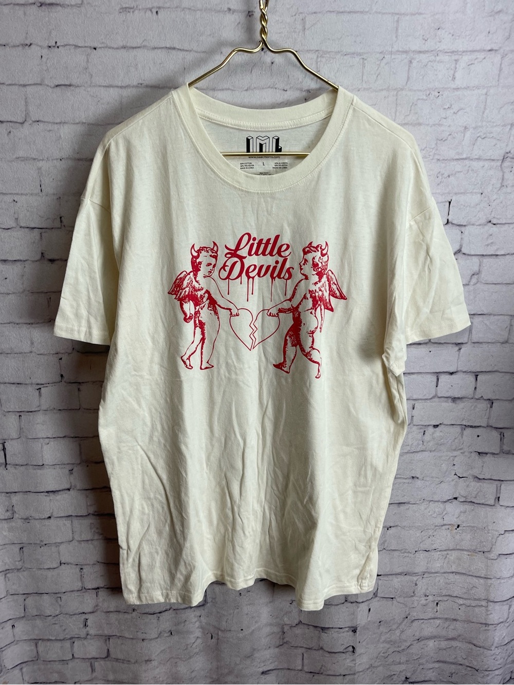 Isaac morris size large cream tee with little devils graphic